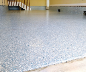 A residential garage with a blue-gray Flake Floor